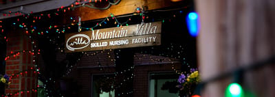 Entrance of Mountain Villa Skilled Nursing Facility adorned with lights