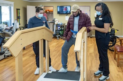 Residents participating in a therapy session with staff