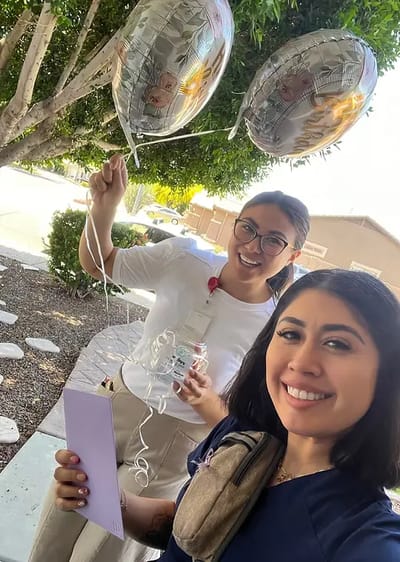 Staff members celebrating with balloons outdoors
