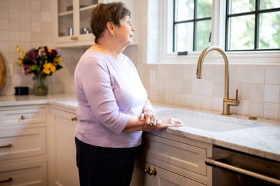 Resident enjoying a moment by the kitchen sink