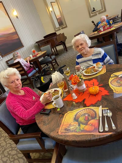 Residents enjoying a meal at a dining table