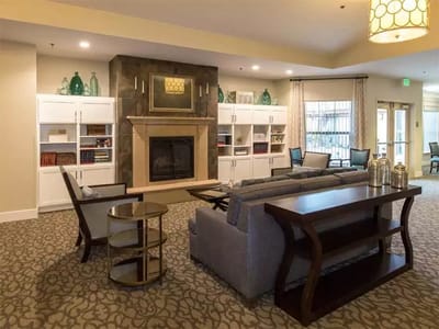 Bright common area with seating and fireplace
