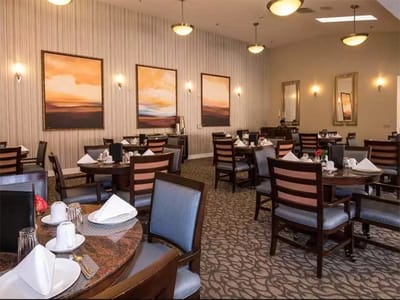 Dining room set for service with artworks on the wall