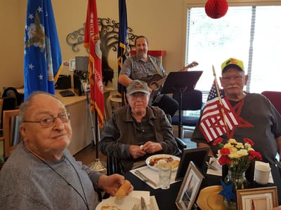 Residents enjoying a musical performance in a communal area