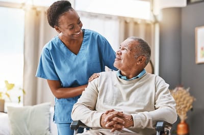Staff member with a resident in a cozy interior setting