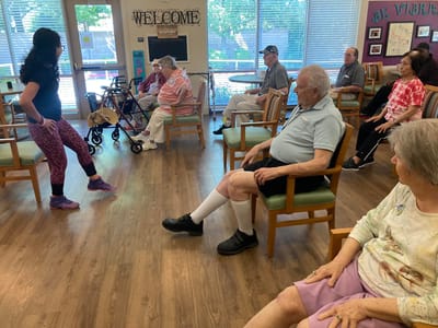 Residents participating in an activity in a bright room