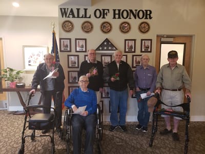 Veterans holding honors in a common area