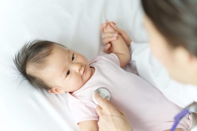 A baby being examined by a healthcare professional