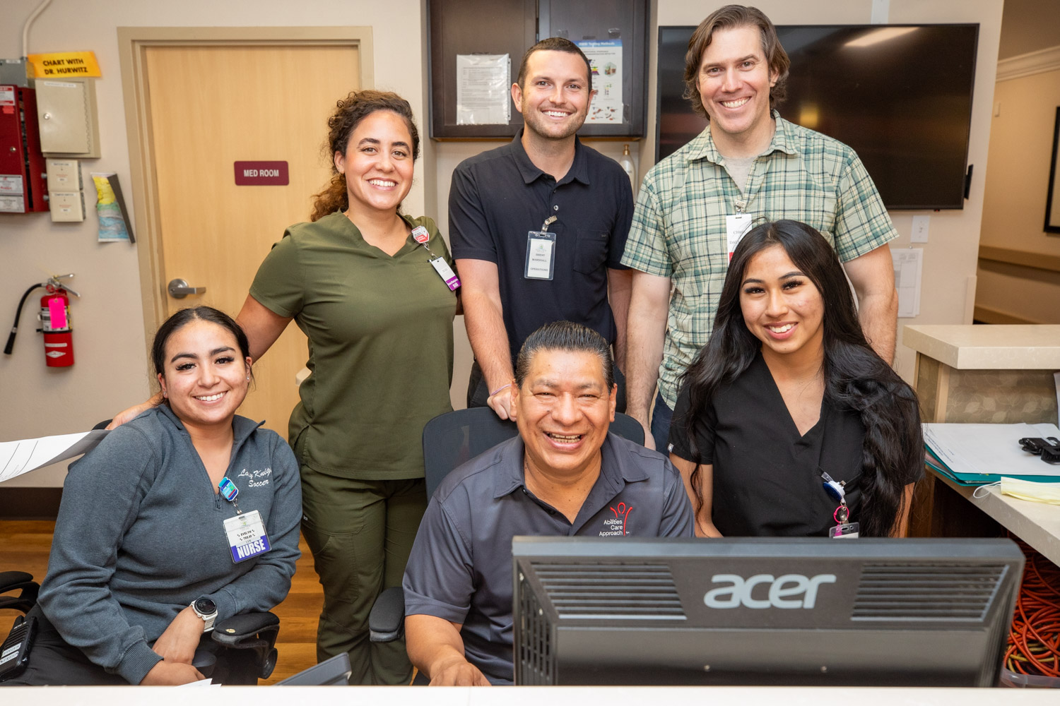 Staff members smiling at the reception desk