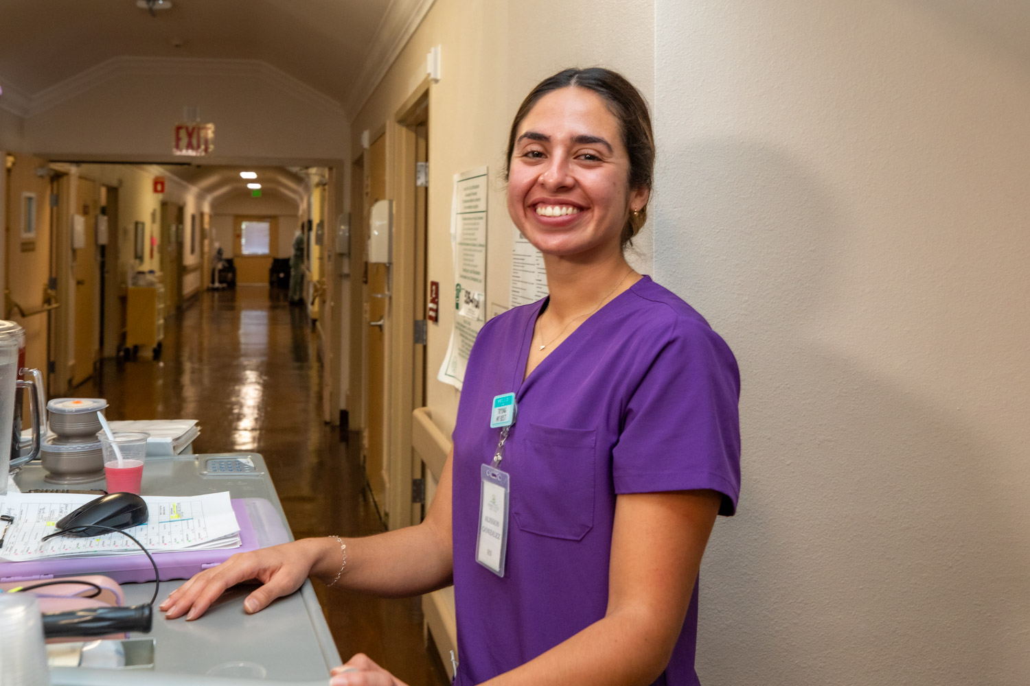 A staff member smiling at the reception desk