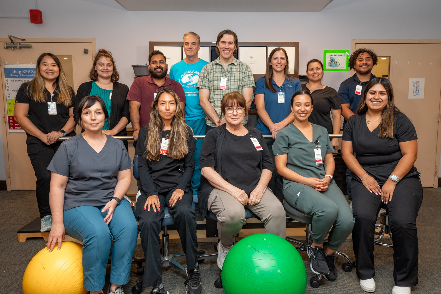 Staff members posing together in an activity room