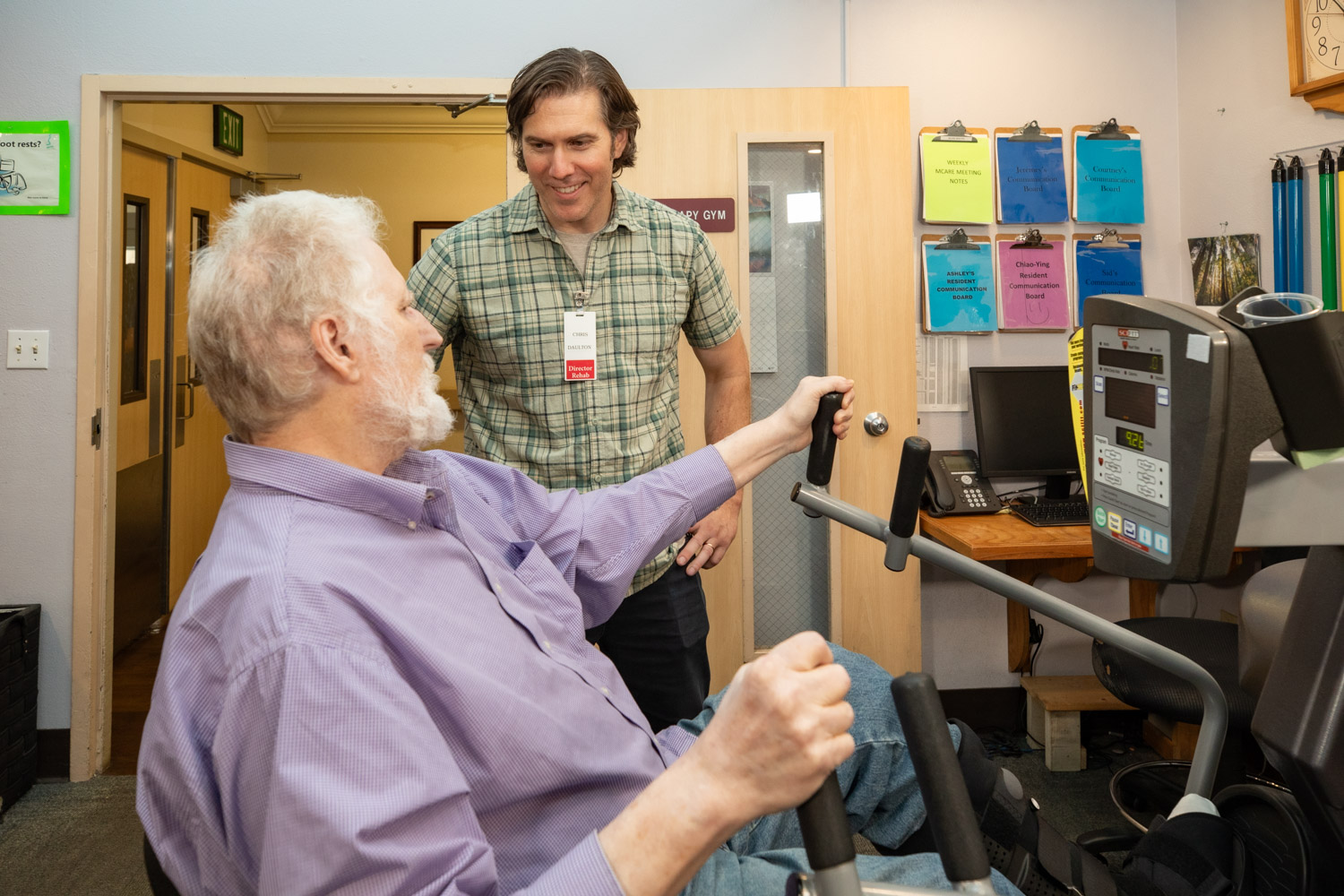 Staff assisting a resident in an exercise activity
