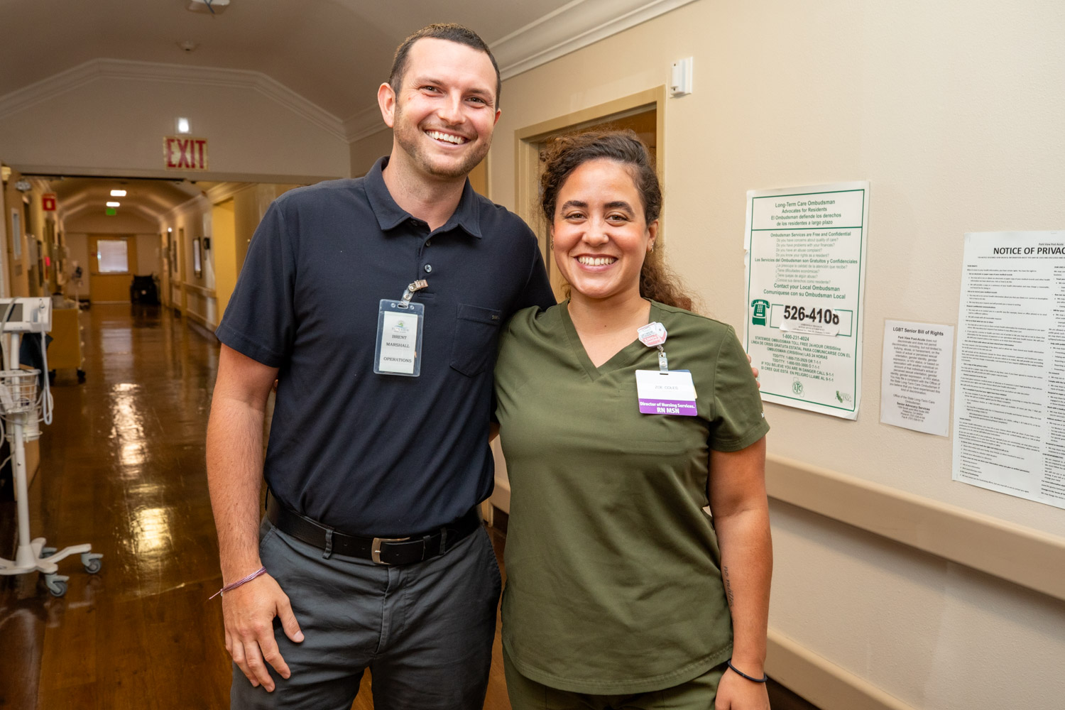 Staff members smiling in a facility hallway