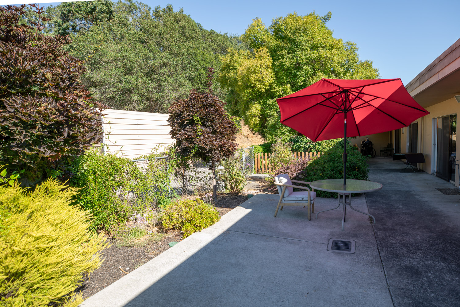 Outdoor seating area with a red umbrella