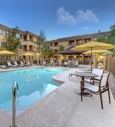 Outdoor pool area with lounge chairs and umbrellas