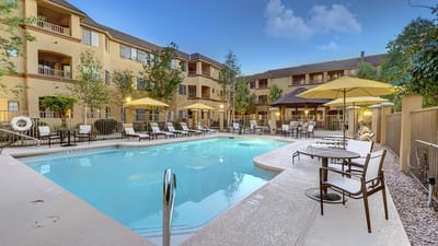 Outdoor pool area with lounge chairs and umbrellas