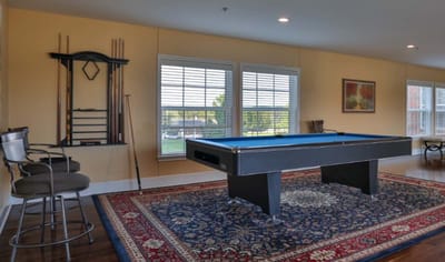 Bright common area with a pool table and seating