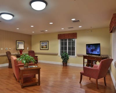 A cozy common area with seating and TV