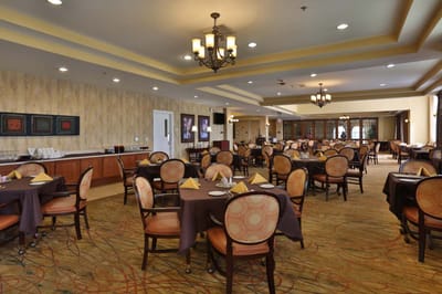 Interior view of the dining room with tables set for a meal
