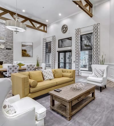A cozy common area with seating in a senior living facility