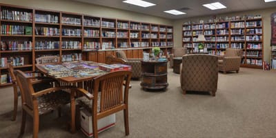 A cozy library with bookshelves and seating