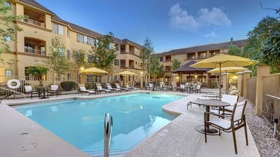 Outdoor pool area with lounge chairs and umbrellas