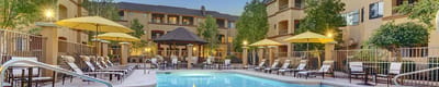Outdoor pool area with lounge chairs and umbrellas