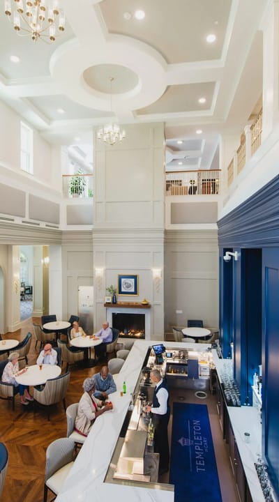 Bright, modern common area with residents and staff