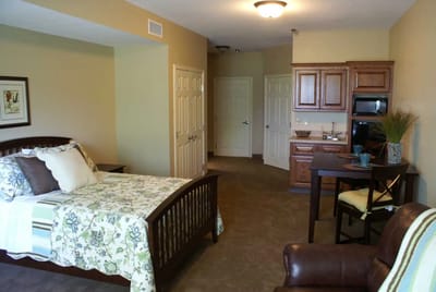 A cozy private room with a bed and seating area