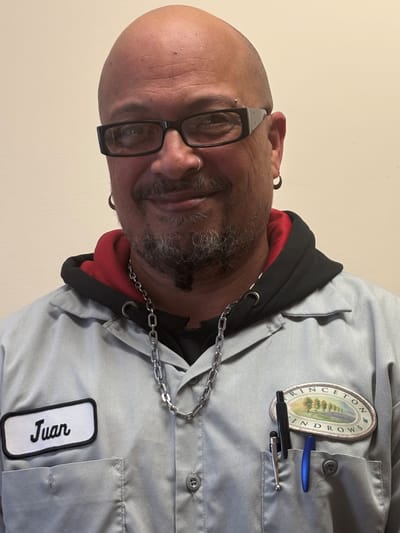 Staff member in uniform smiling at the camera