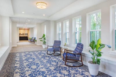 Bright interior corridor with seating and plants