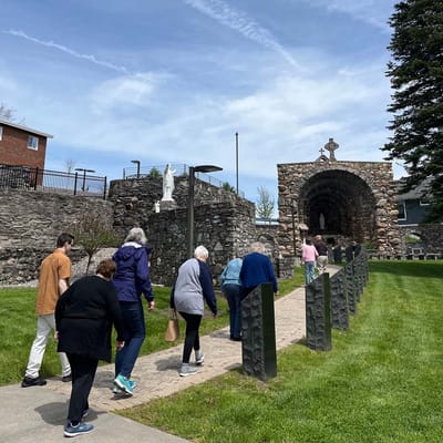 Residents walking on a pathway in a landscaped area