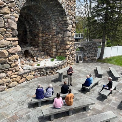 Residents engaging in an outdoor activity with a speaker