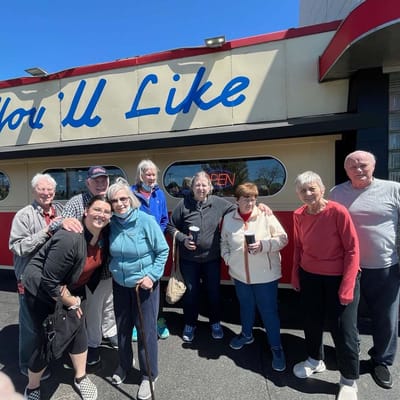 Group of residents outside a diner enjoying time together