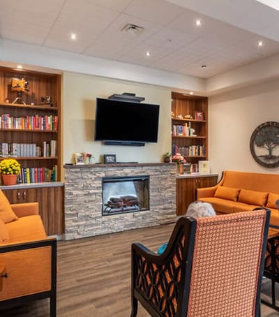 A cozy common area with bookshelves and seating