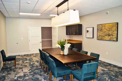 A dining room area with a long table and chairs