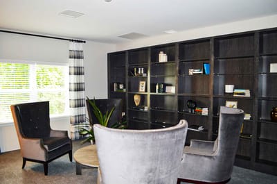 Bright common area with comfortable seating and bookshelves.