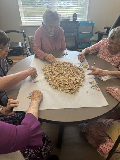 Residents enjoying a group activity at a table.