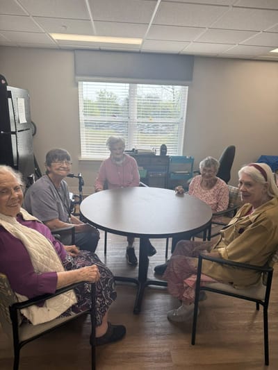 Residents enjoying time together at a table in a common area
