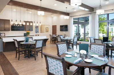 Bright dining area with tables and chairs set up