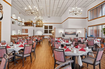 Bright dining room with tables set for a meal