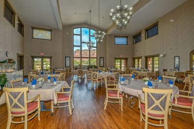 Dining room setup with large windows and elegant decor