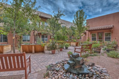 A tranquil outdoor garden area with seating and a fountain