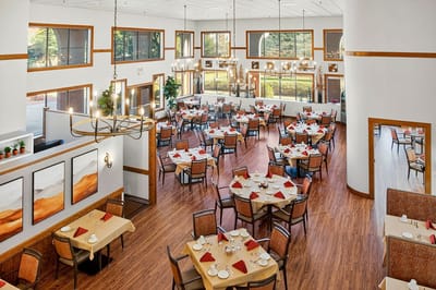 Bright dining room with tables set for a meal