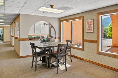 Interior common area with dining table and windows