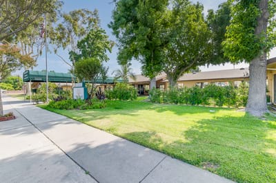 Exterior view of Santa Anita Assisted Living with green landscaping