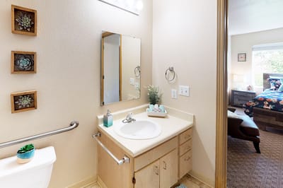 Brightly lit resident bathroom with modern fixtures