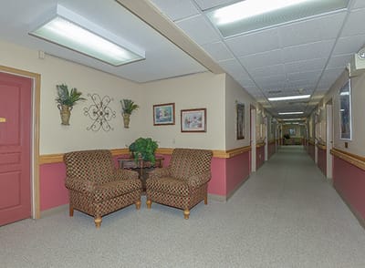 Interior hallway with seating area in a senior living facility