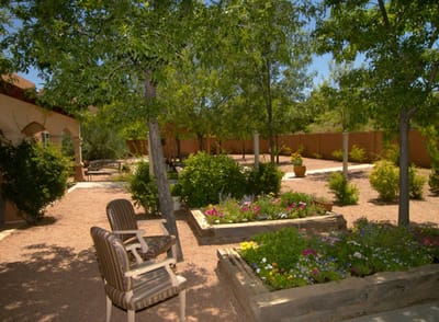 Serene garden area with seating and flowering plants.