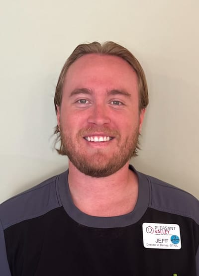 A staff member smiling for the camera